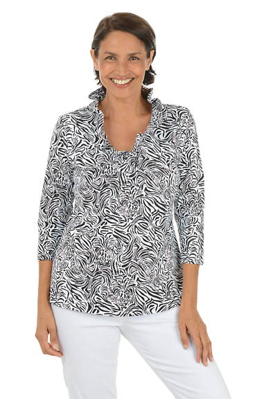 A woman wears a v-neck silver drinks top.