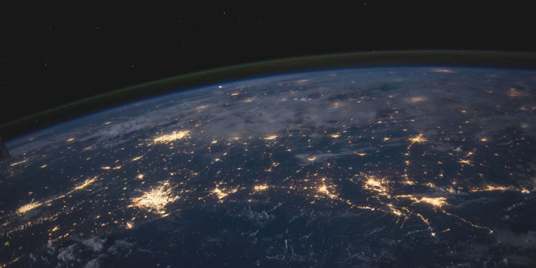 An outer-space view of the Earth showing electronic communications networks