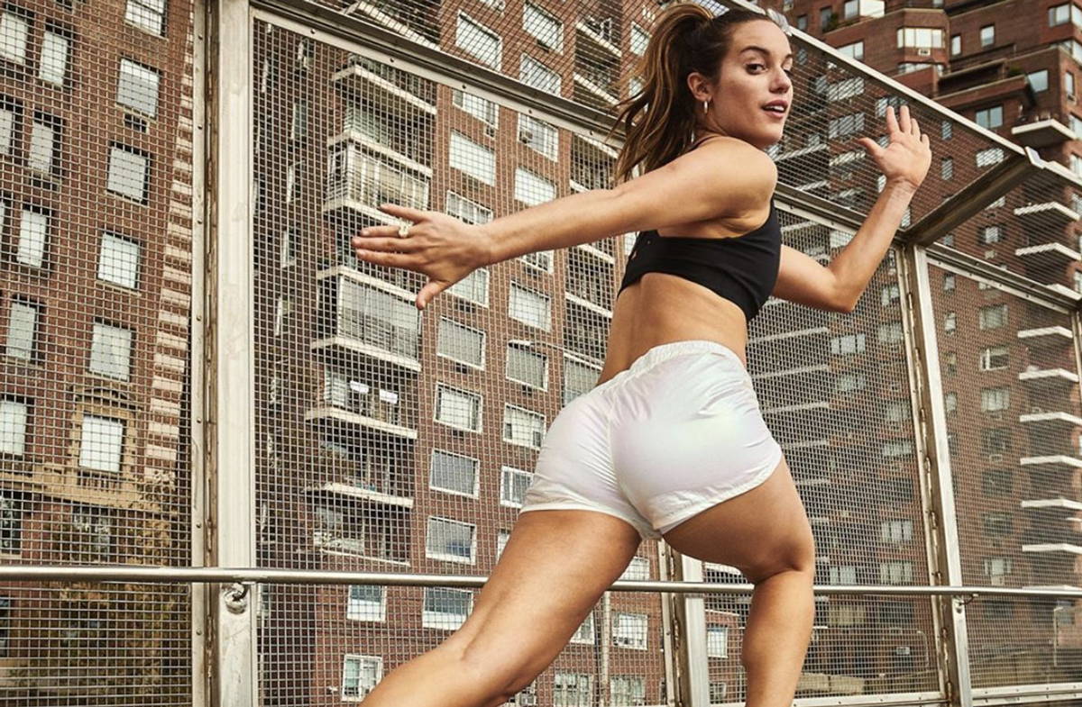 Ex-tennis player Hannah Berner running and looking over her shoulder in a black sports bra and white shorts