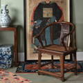 The classic Chinese horseshoe chair, Qing dynasty with a rattan seat, besides an ancestor painting and blue and white Chinese porcelain