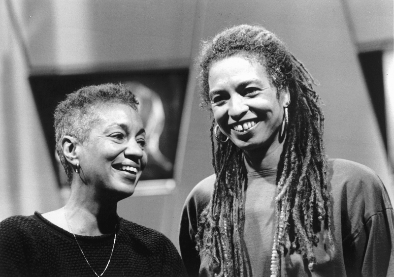 June Jordan and Angela Davis smiling standing next to eachother.