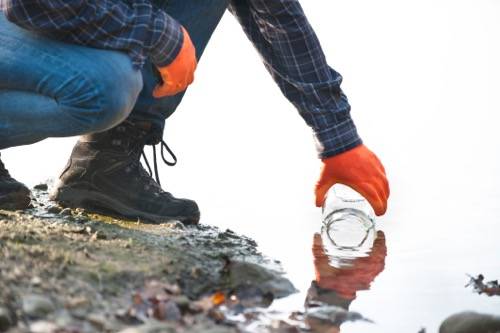 photo of a man collecting water