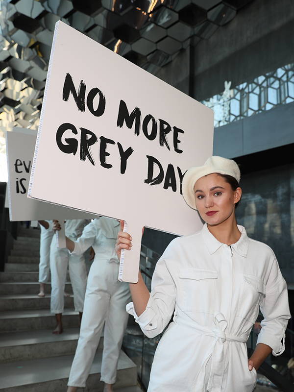Image of a model holding a sign from the World Wide Hair Tour of 2019