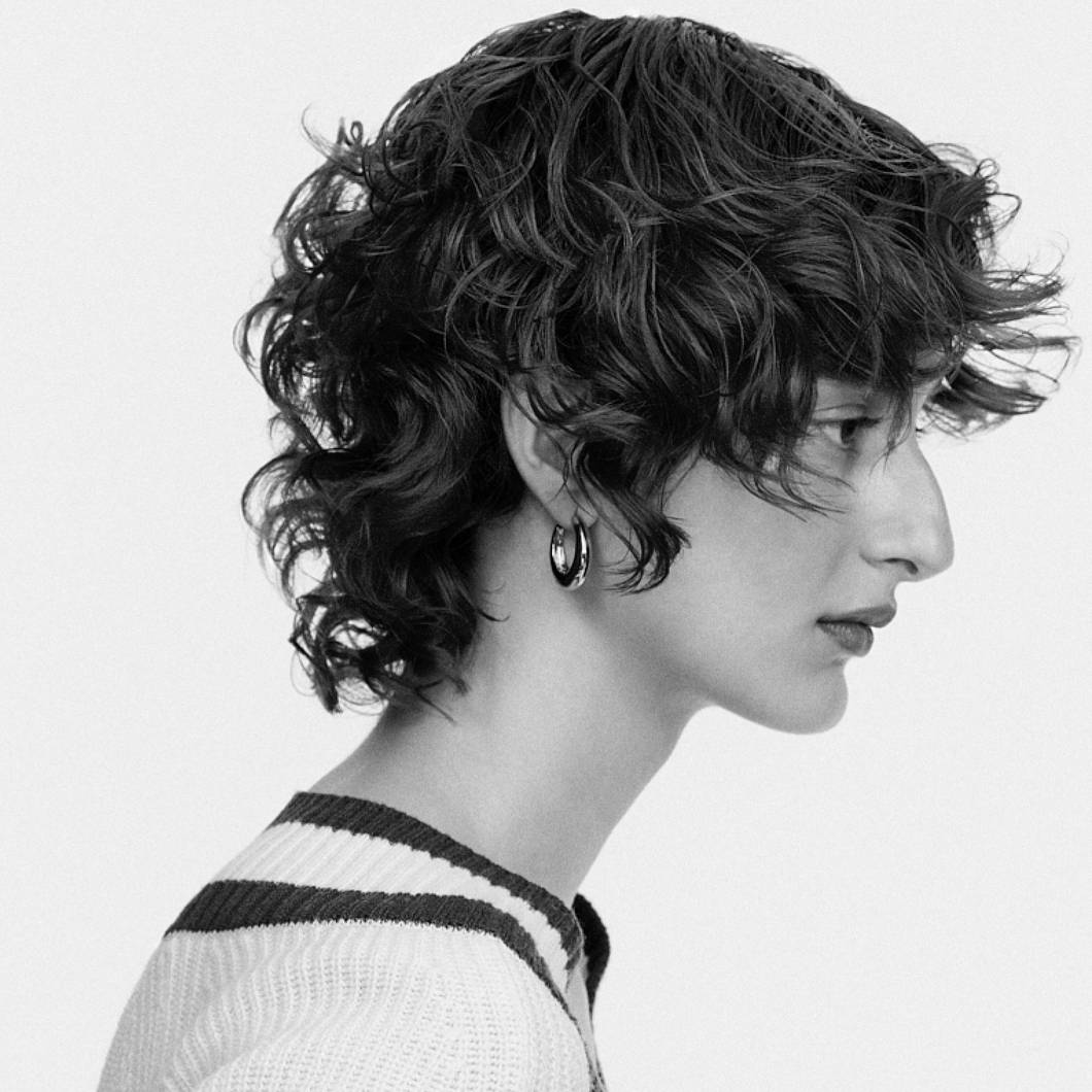 Model with short curly hair