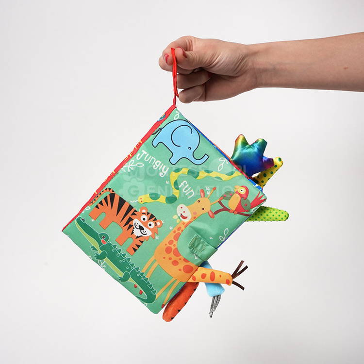 A hand holding the Montessori Baby Soft Book Jungle.