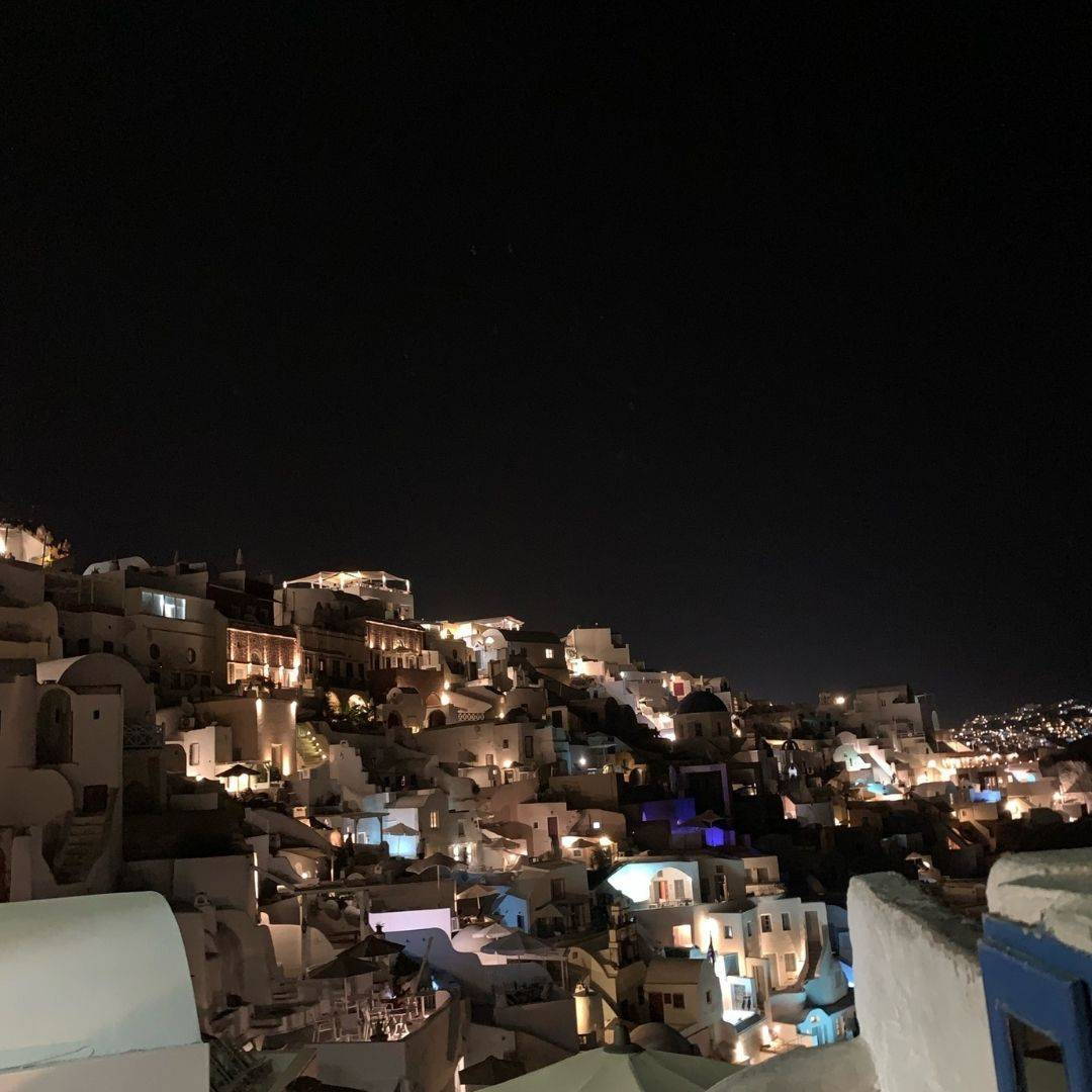 Cavotagoo infinity pool overlooking Santorini caldera at sunset