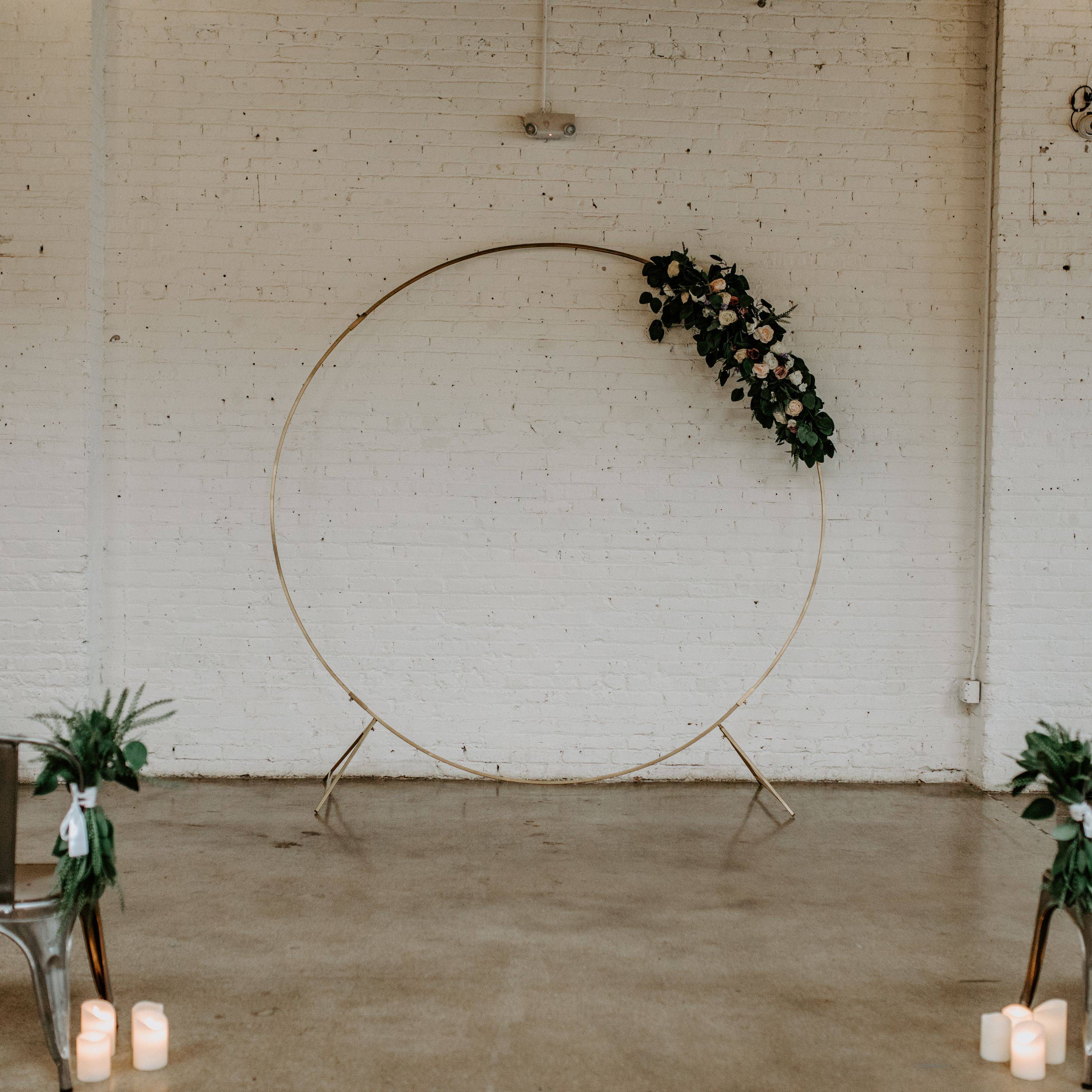 Compass Rose Floral's new gold circle wedding arch with a stunning boho pampas grass swag 