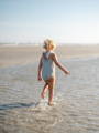 Girl Walking Along Beach Shore