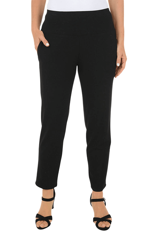 A woman wearing a black pant against a beige background