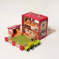 Wooden farm playset with a barn, animal figures, fenced field, and toy truck.