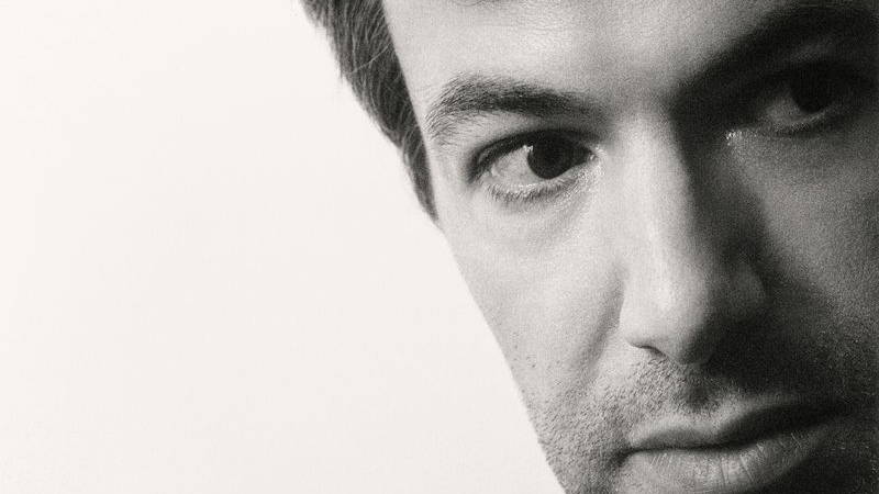 Nathan Fielder in black and white looking off to the side of the page
