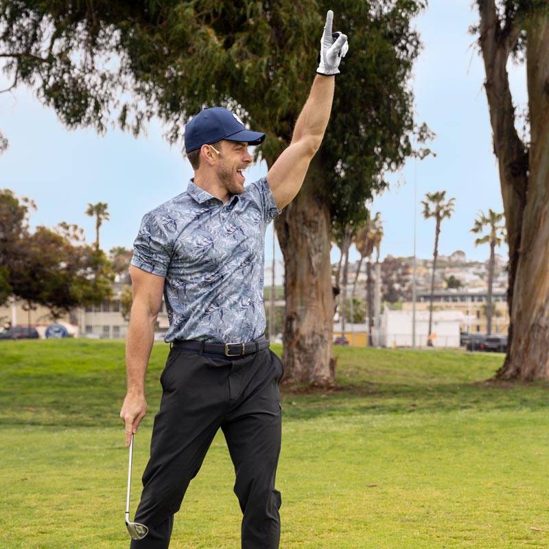 man playing golf while wearing Black Clover polo