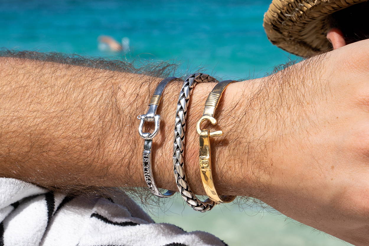 Man with his hand on the back of his head wearing Vibe Jewelry men's bracelets.