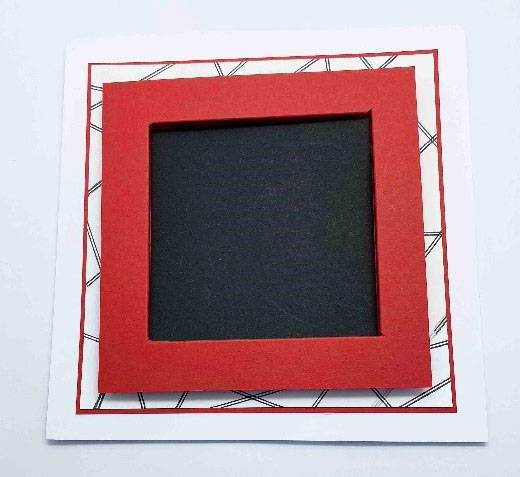 The red frame is glued down onto the randomly stamped stem line background