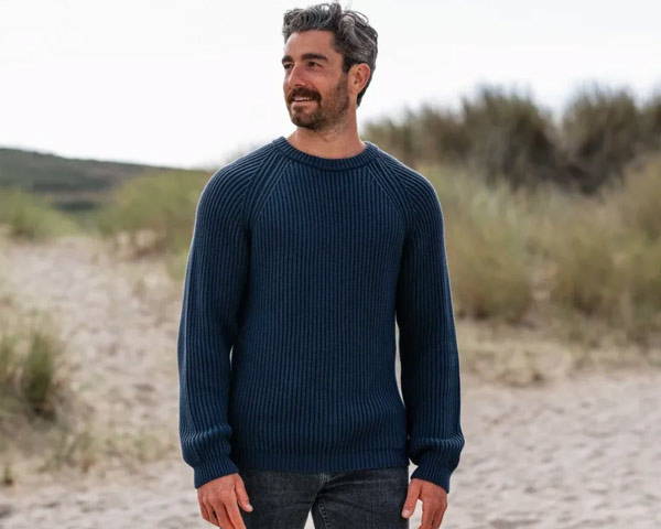 Man wearing organic cotton knitted jumper from UK Men's Sustainable Clothing brand Rapanui