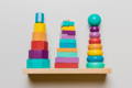 Colorful Montessori stacking toys on a shelf.