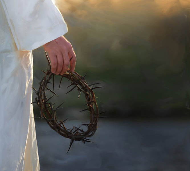 Jesus' hand holding a crown of thorns. Sunlight shines on a new day.