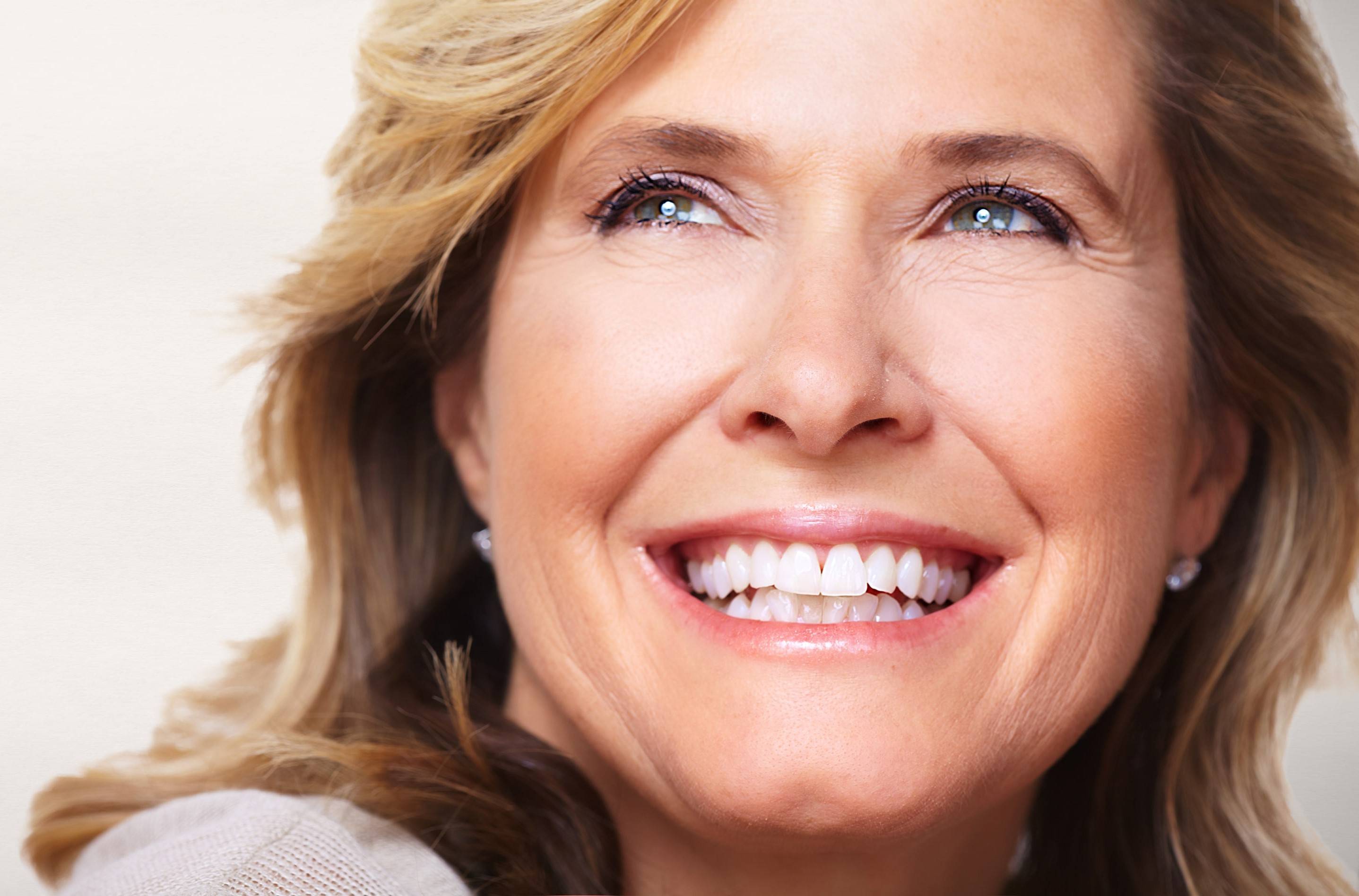 mature woman looking up and smiling 