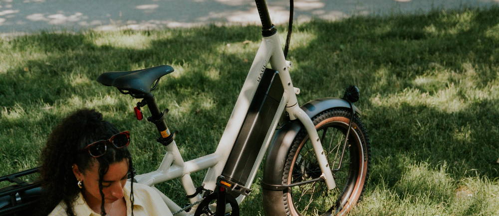 A Woman sitting next to a Globe Haul e-Bike