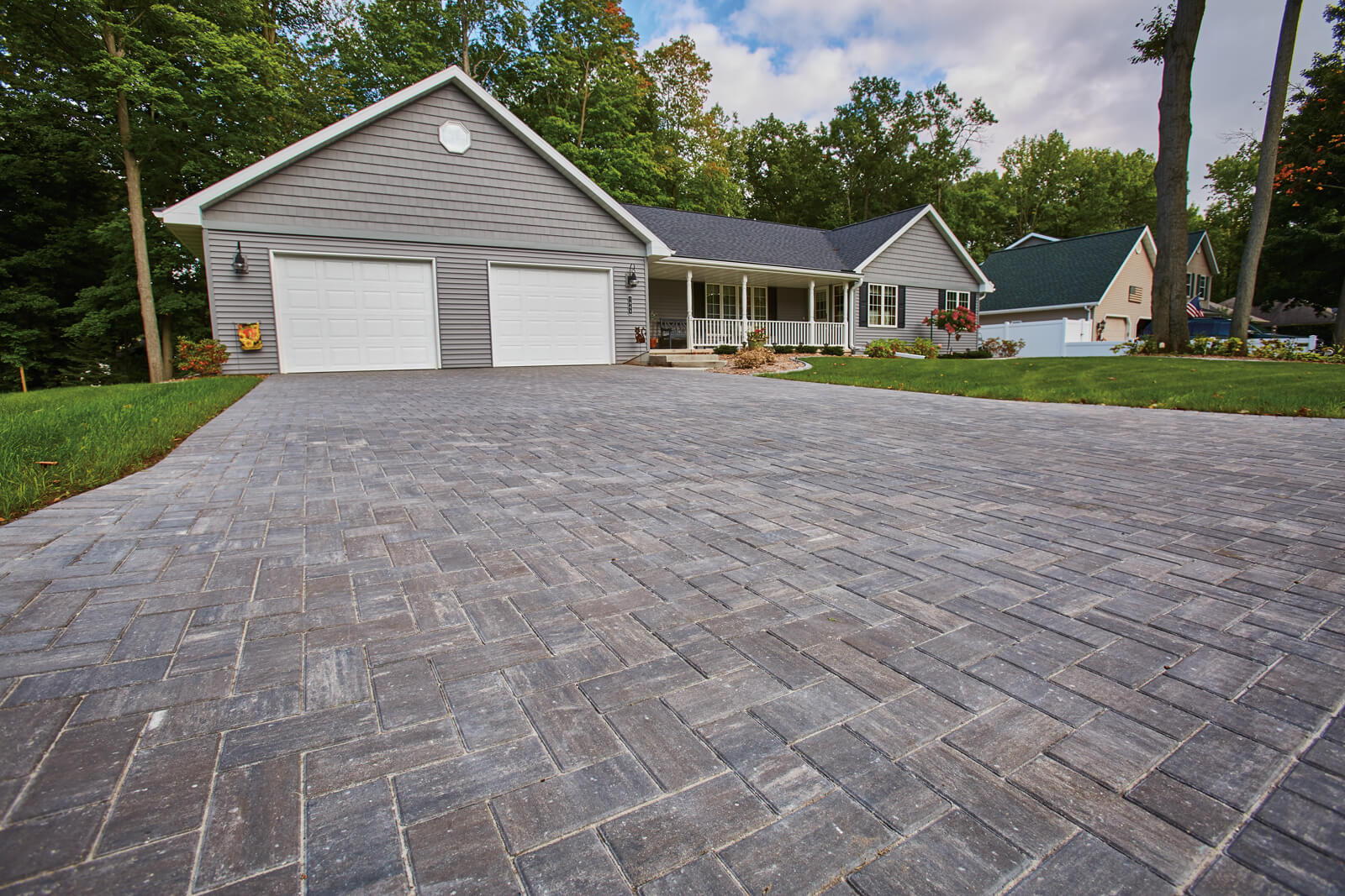 Herring Bone pavered driveway leading up to a house