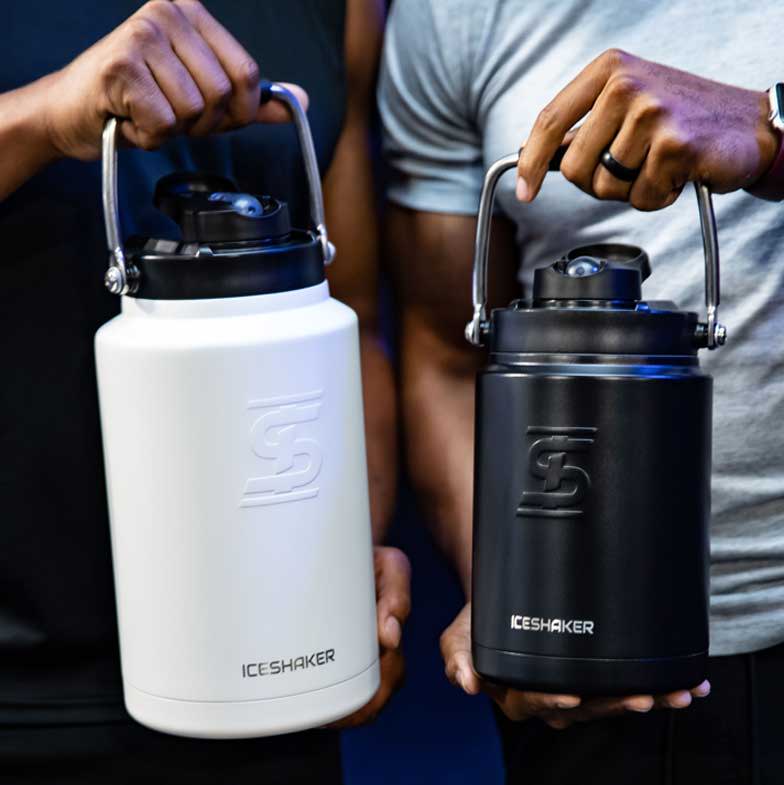 A close up image of two men. One man is holding a white one gallon Ice Shaker Jug while the other man is holding a black Ice Shaker Half Gallon Jug.