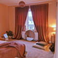 blush velvet curtains hanging in a bedroom