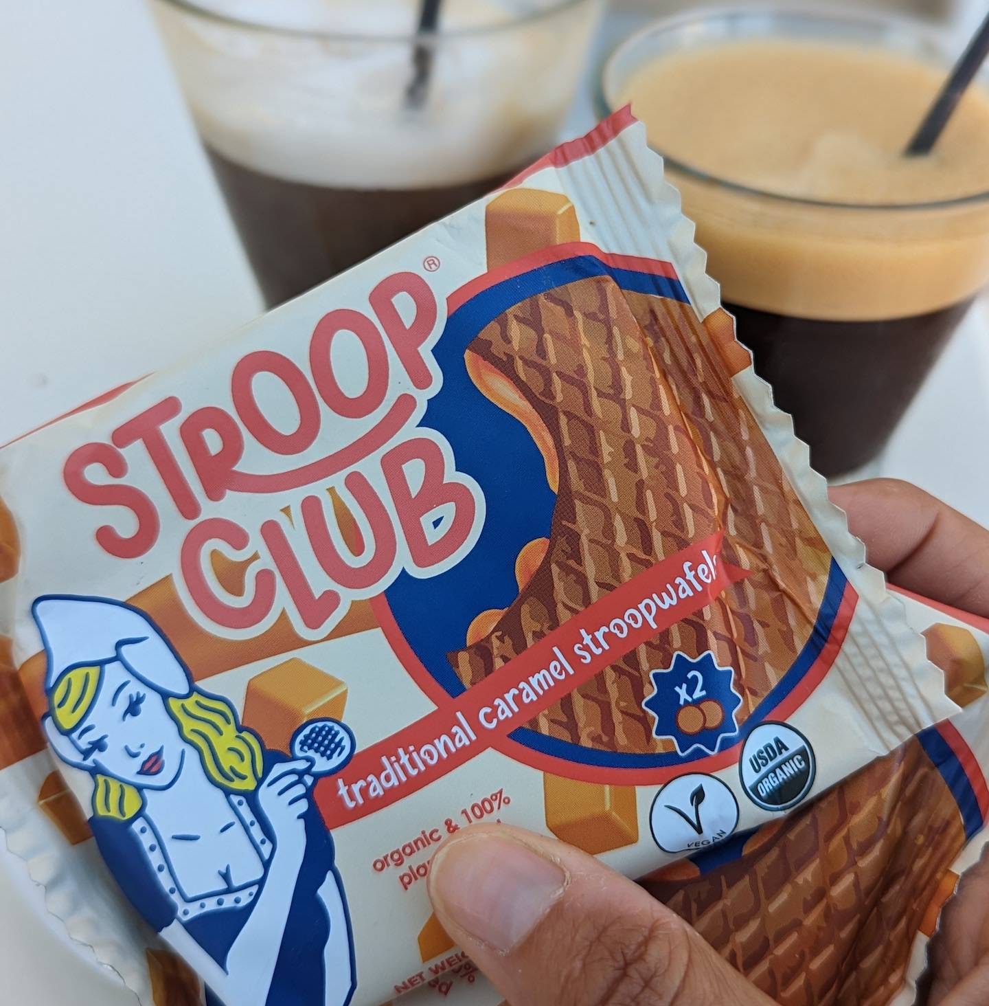 Picture of a stroopwafel being handed to someone