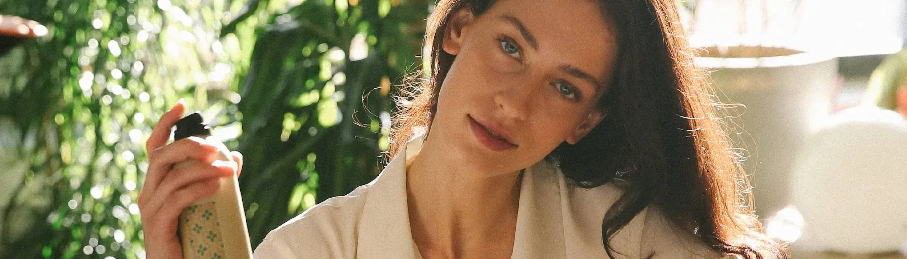 woman with green eyes using Davines This Is A Medium Hairspray