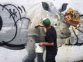 cleaning graffiti from a mural