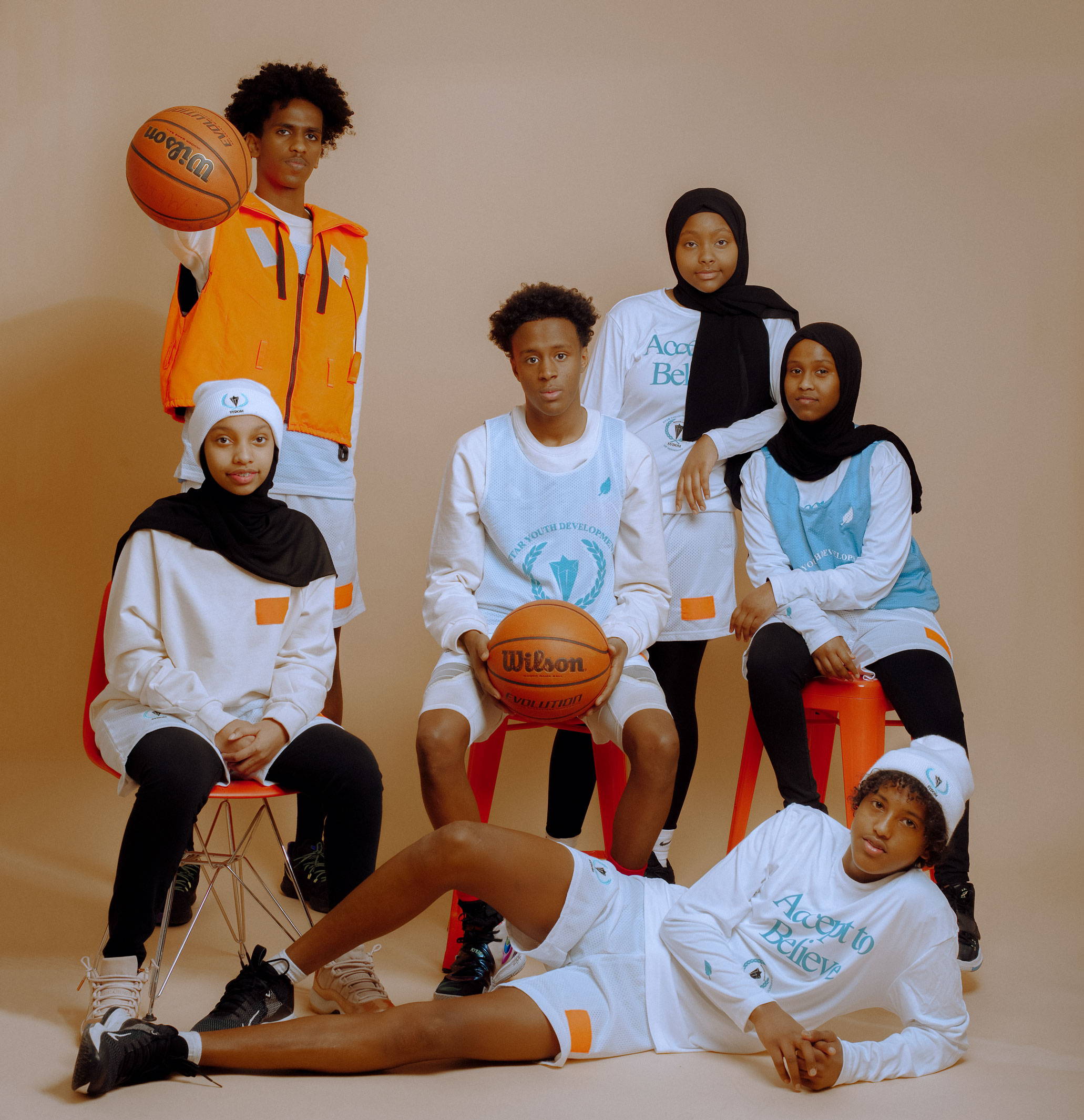 SYDOM & Epimonia Partnership Team Photo of Teenagers Wearing Basketball Uniforms