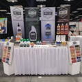 white poly knit skirt on a trade show table with products on it