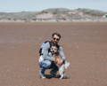 dog with dog dad in desert posing for photo