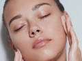 woman applying serum on her face