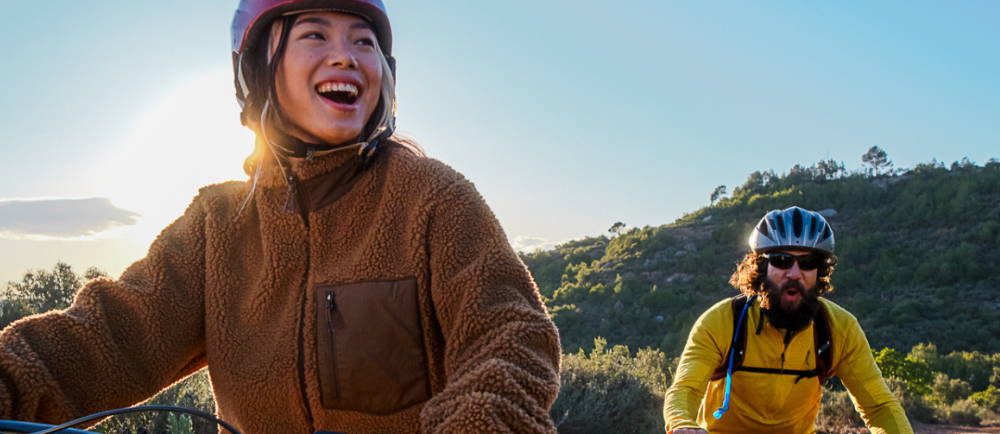 a man and a woman e-biking in the wilderness
