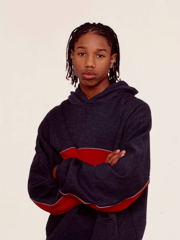 Image may contain: Michael B. Jordan, Clothing, Knitwear, Sweater, Sweatshirt, Hoodie, Child, Person, Face, and Head