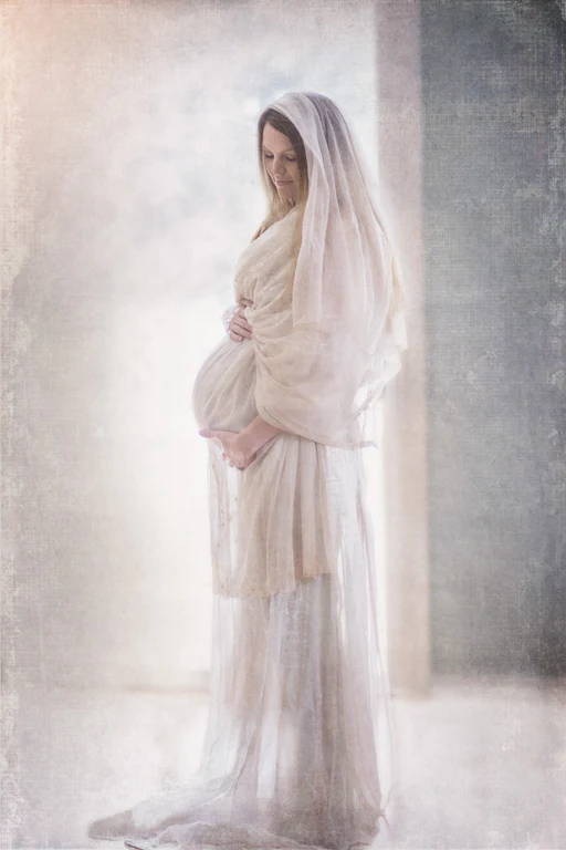 A pregnant woman in a white robe.