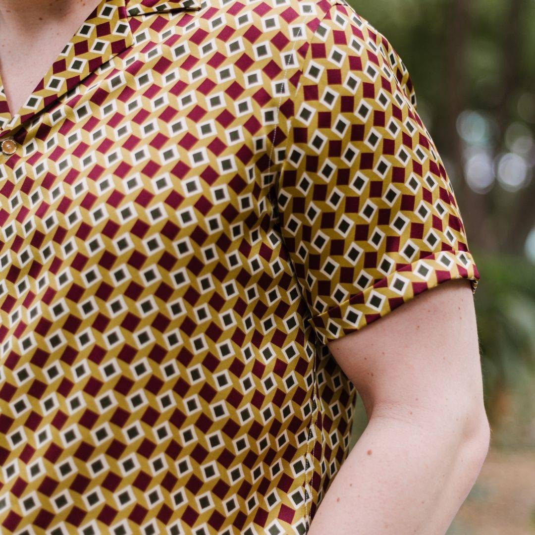 close up image of the short sleeve gold bowling silk shirt from 1000 kingdoms