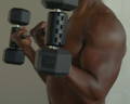 man doing ez bar curls. 