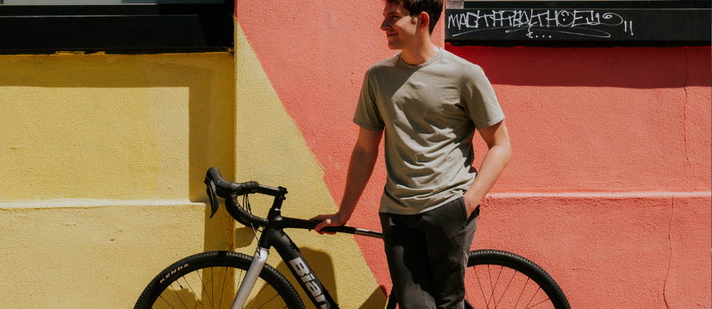 a man standing next to an electric road bike