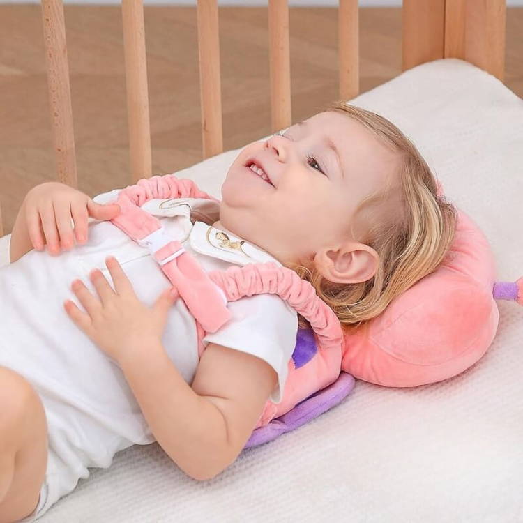 Blonde-haired baby laying on her back with the Montessori Baby Guardian below her keeping her safe.