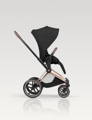 Black Cybex Priam Seat on the Rosegold frame of the stroller, in front of a White Studio Background.