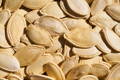 alt="Closeup of raw pumpkin seeds"