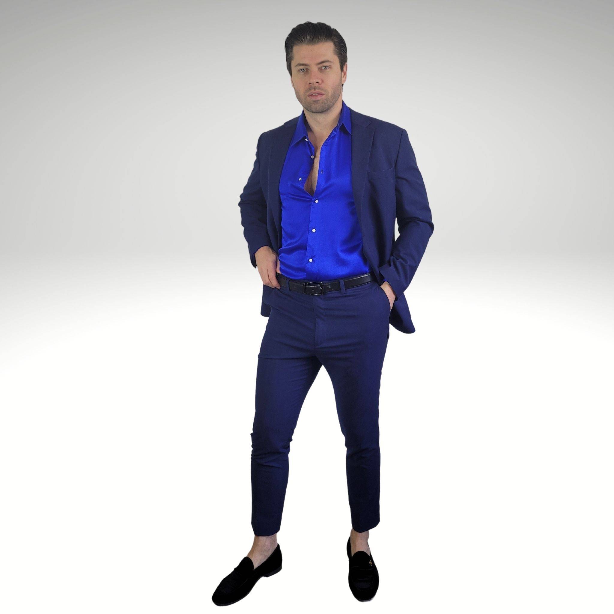 model wearing a blue silk shirt with a navy blue suit and black velvet loafers