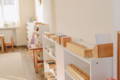 A classic Montessori style playroom setup with white shelves and wooden toys.