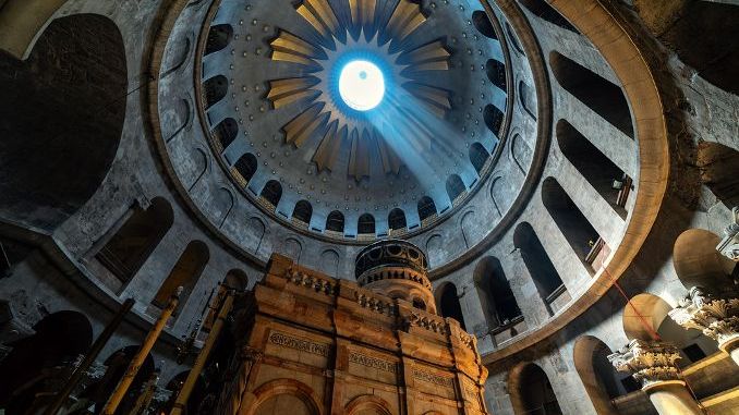 Ray of sunlight breaks through the ceiling over the tomb of Jesus in the Church of the Holy Sepulchre in Jerusalem, Israel