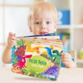 Little boy holding the Montessori Sticker Busy Book. 