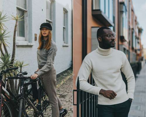 Woman wearing Grey fisherman jumper and man wearing cream submariner jumper with black trousers from sustainable knitwear brand Beacon and Armour