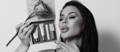 Gorgeous woman holding the ARMÉE cosmetics lip care kit