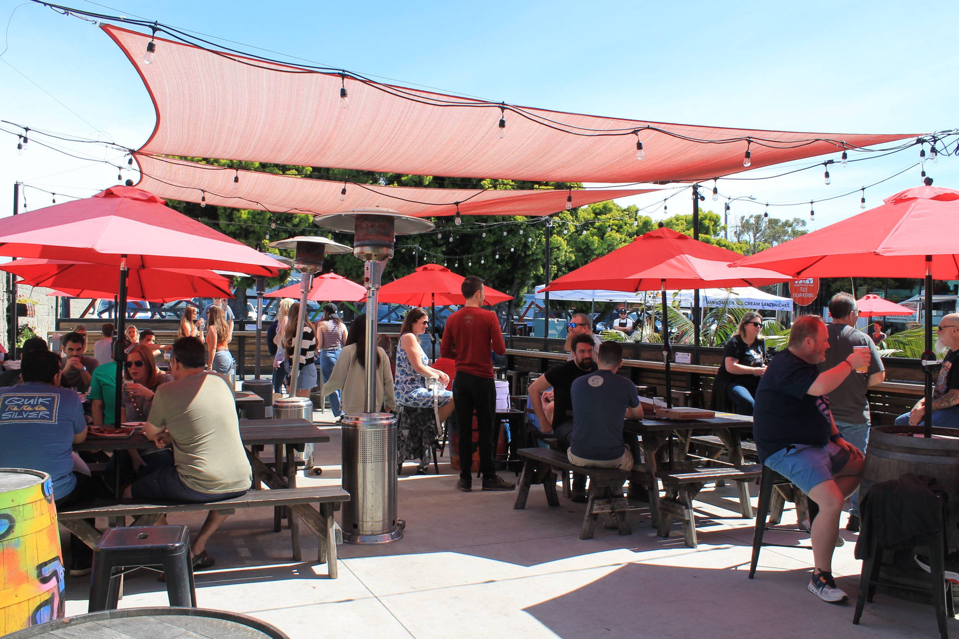 a view of the patio at the Brewery and Taproom. Guests are enjoying an informative beer dinner.