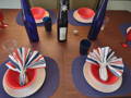 red, white, and blue striped napkins on a table setup with red and white plates and blue placemats